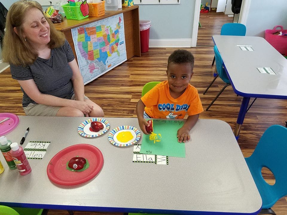 Adult and child at a table with craft supplies