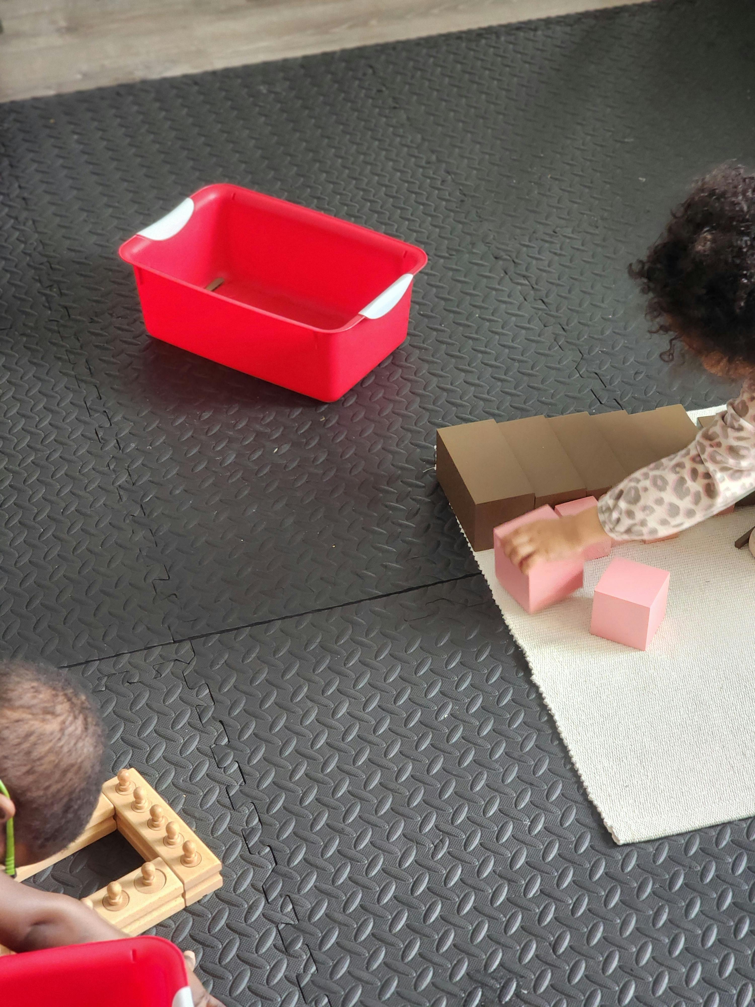 Child building with blocks on a rug