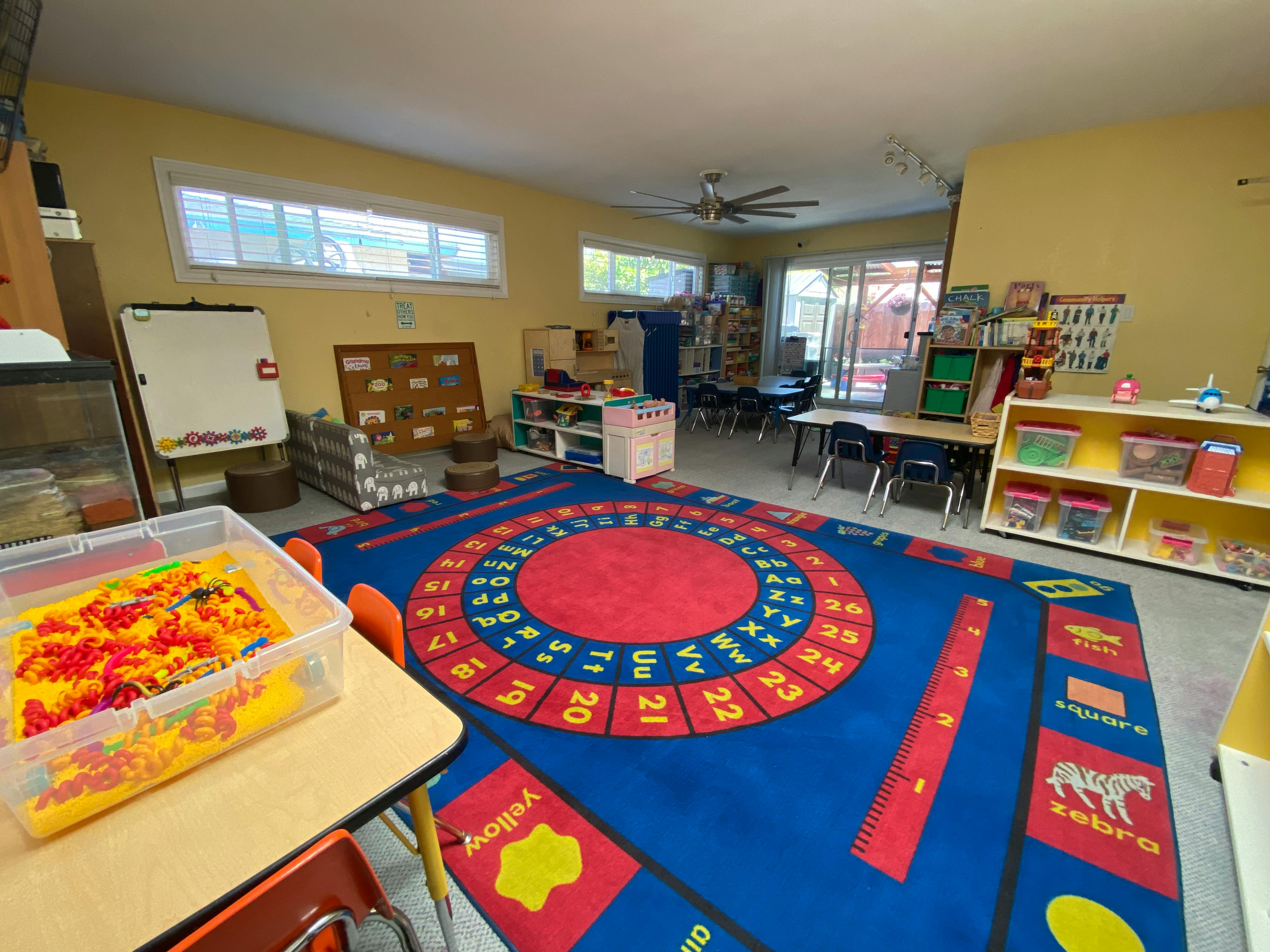 Classroom with a colorful alphabet and number rug
