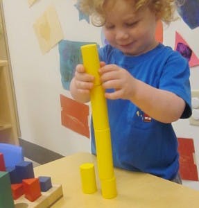 Child playing with yellow blocks