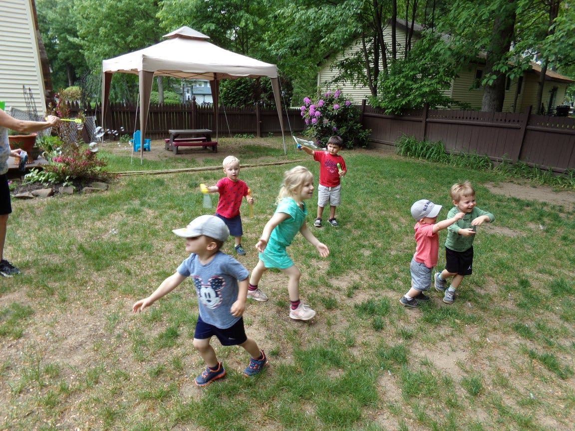 Children playing outdoors in a grassy area