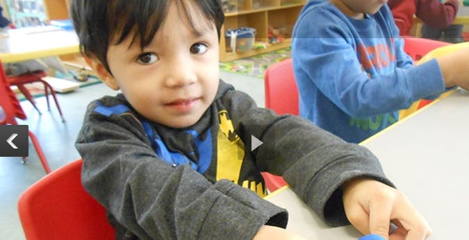 Child at a table in a classroom