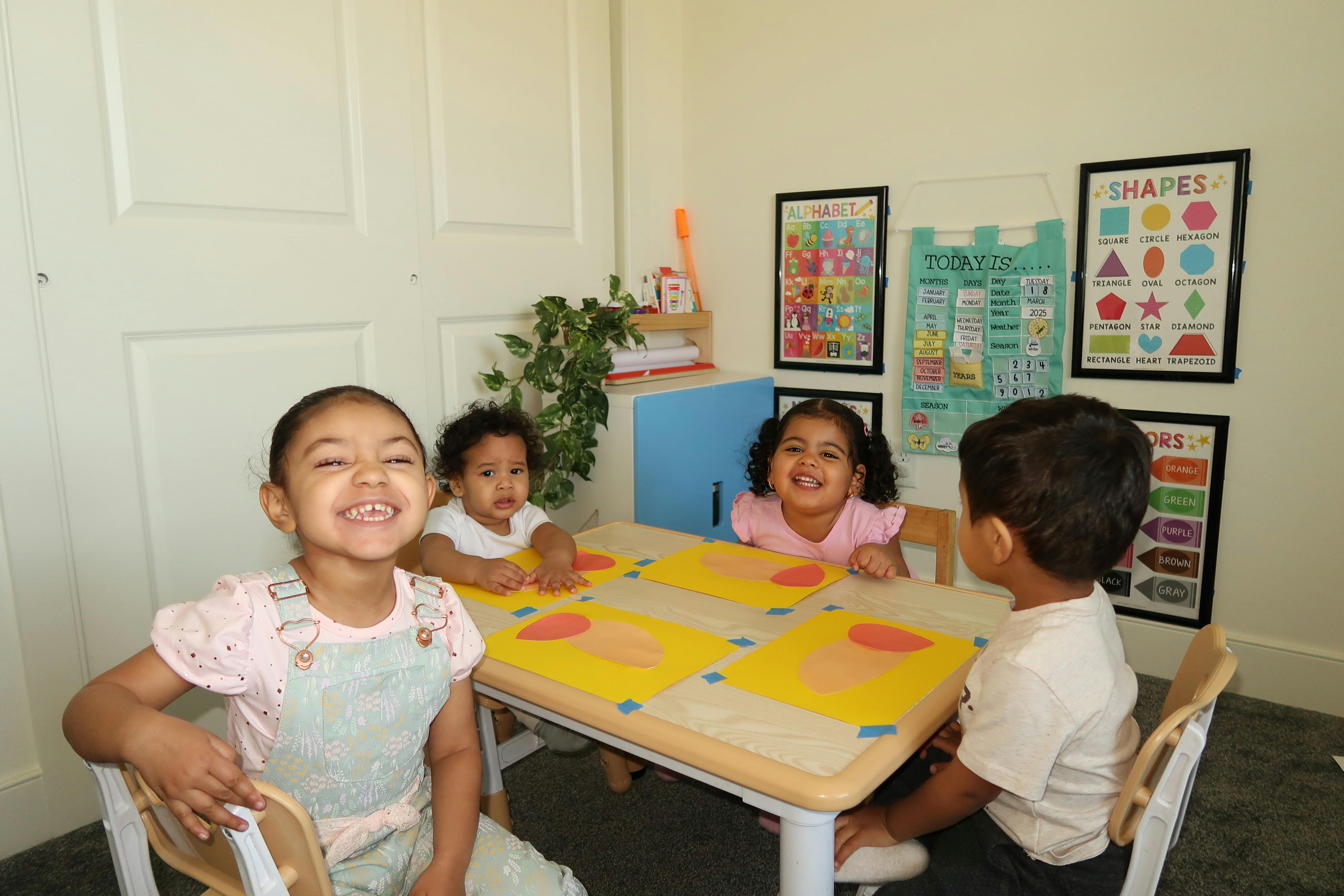 Four children sitting around a small table