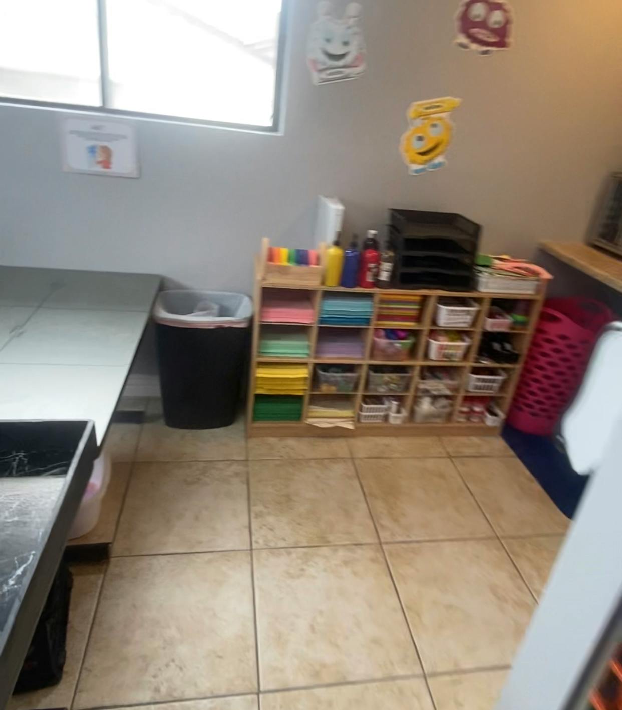 Shelving unit with colorful paper and supplies in a room