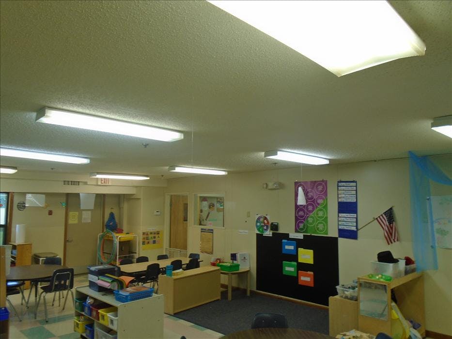 Classroom with small tables, chairs, and learning materials