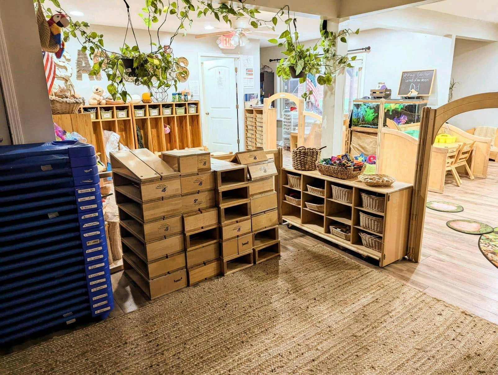 Classroom with wooden shelves, baskets, and a blue storage unit