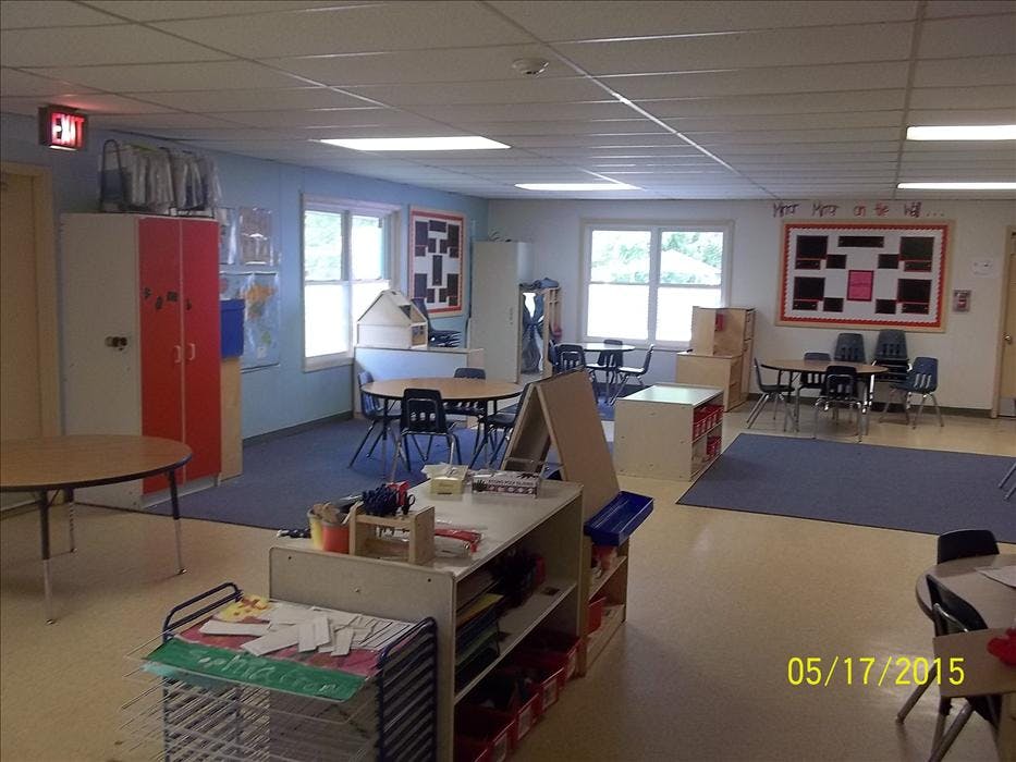 Empty classroom with small tables and chairs
