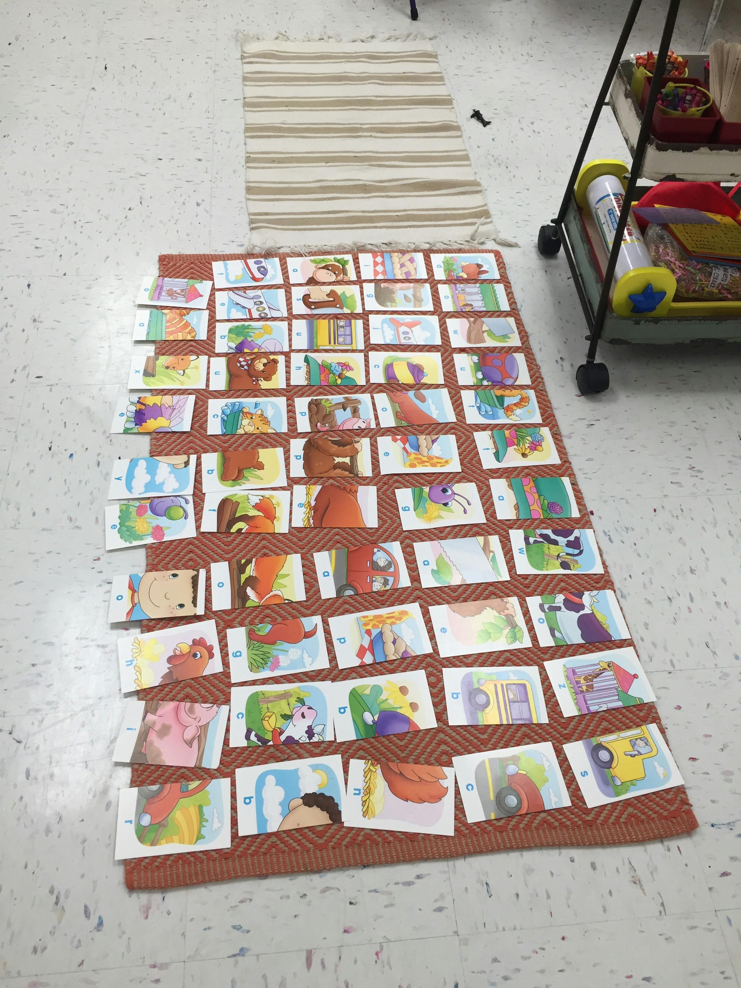 Flashcards with colorful illustrations laid out on a rug