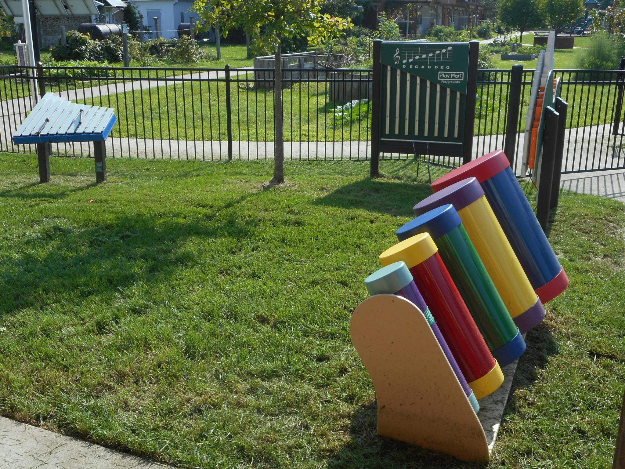 Colorful outdoor musical instrument with tubes of varying sizes