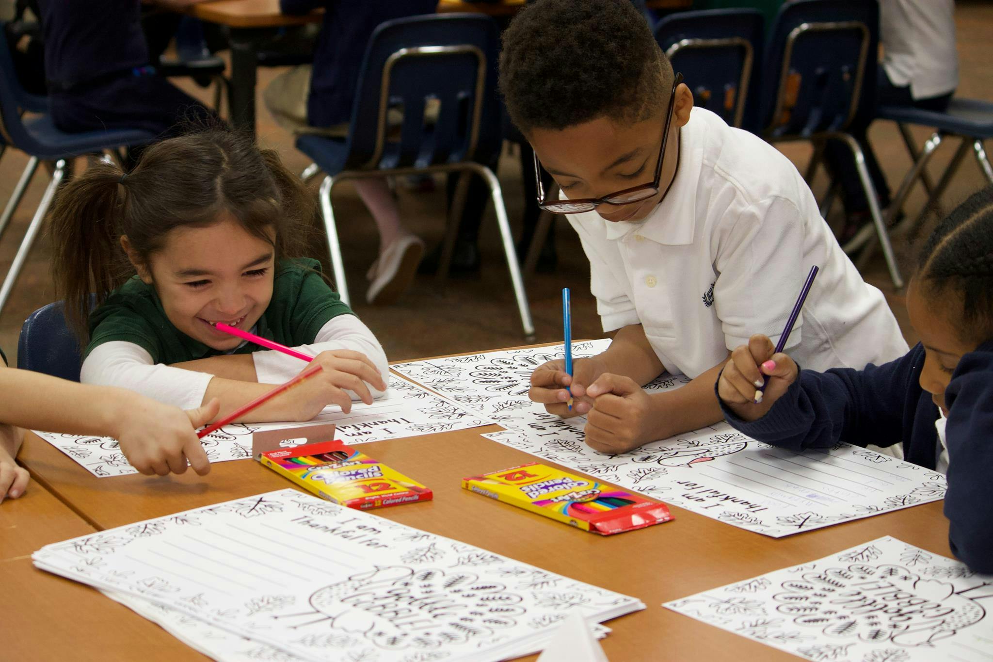 Three children coloring at a table