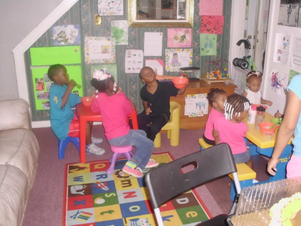 Children sitting at small tables in a room