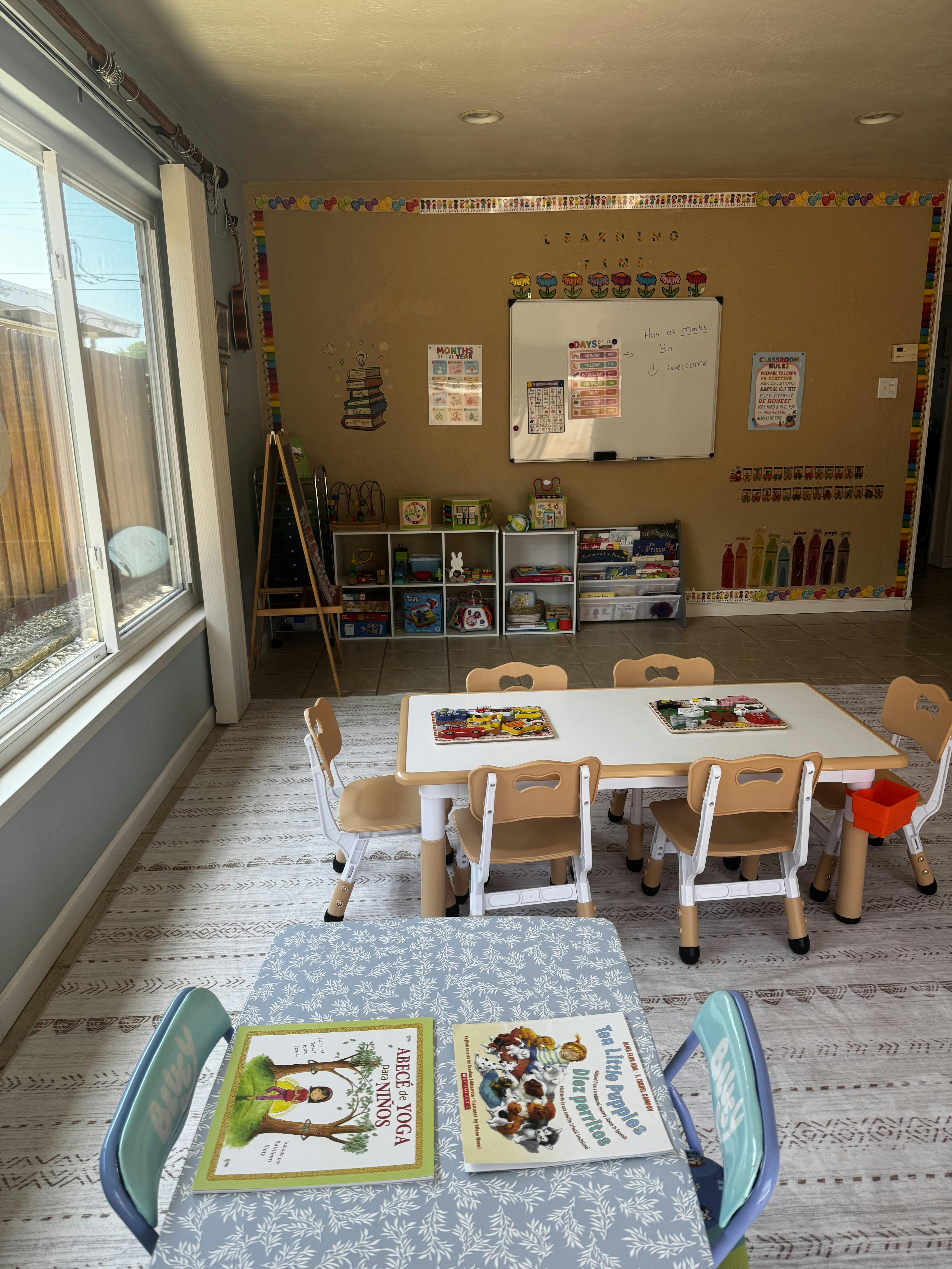Classroom setting with children furniture and books on tables