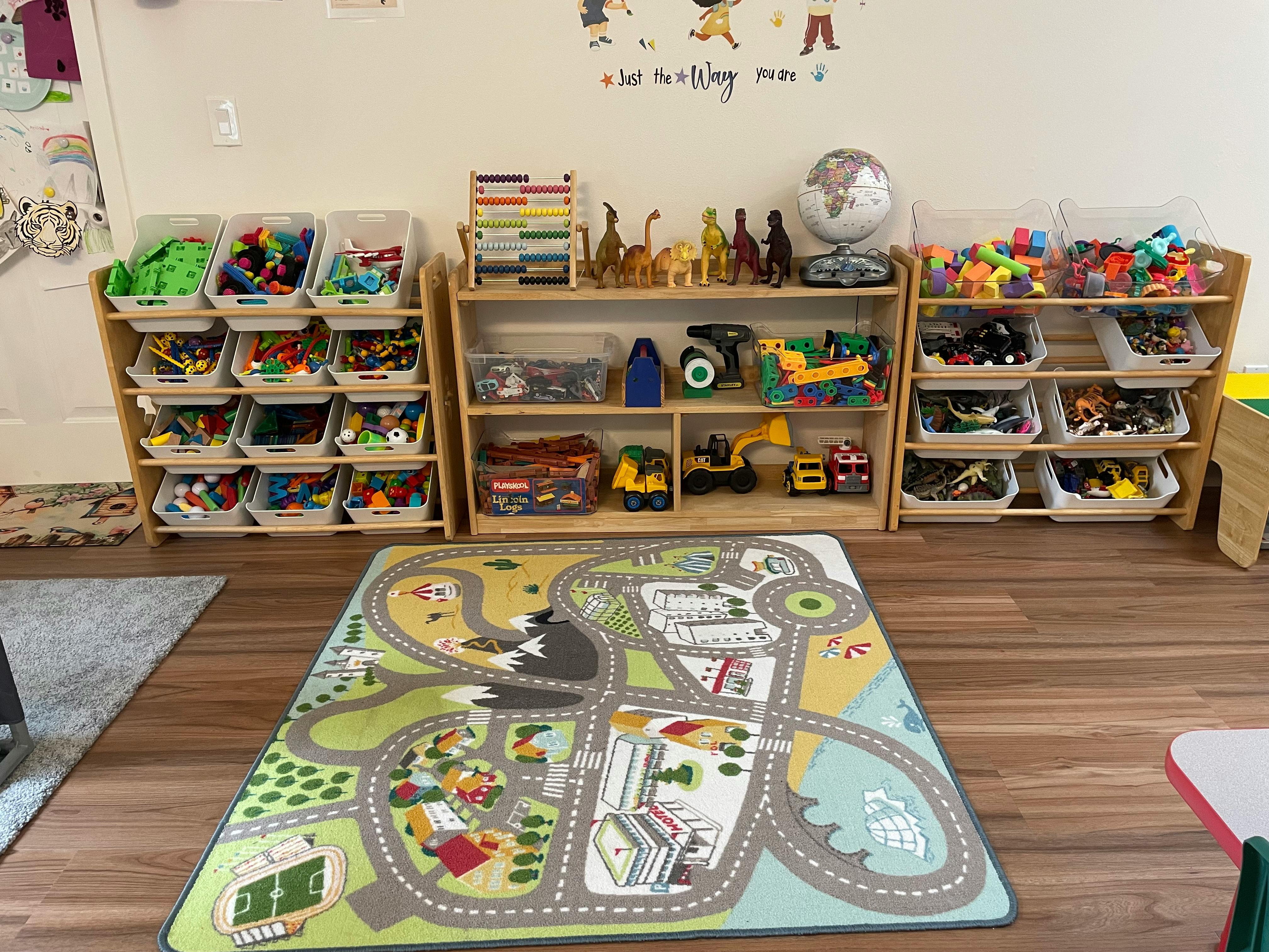 Playroom with toy shelves and a road map playmat