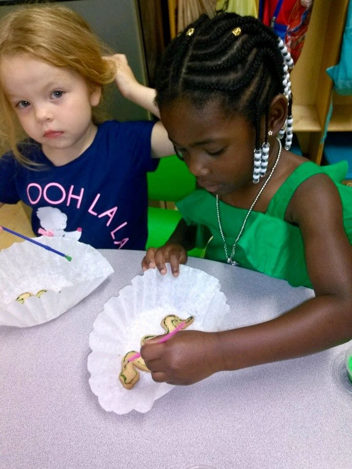 Two children painting in a classroom