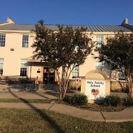 Holy Family School sign in front of a building