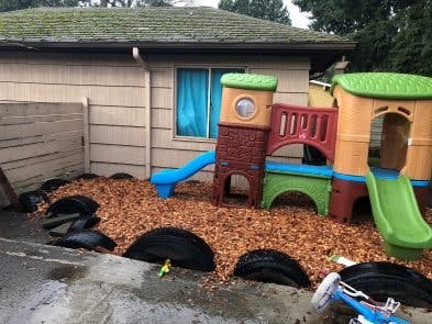 Playground with slides and climbing structures on wood chips