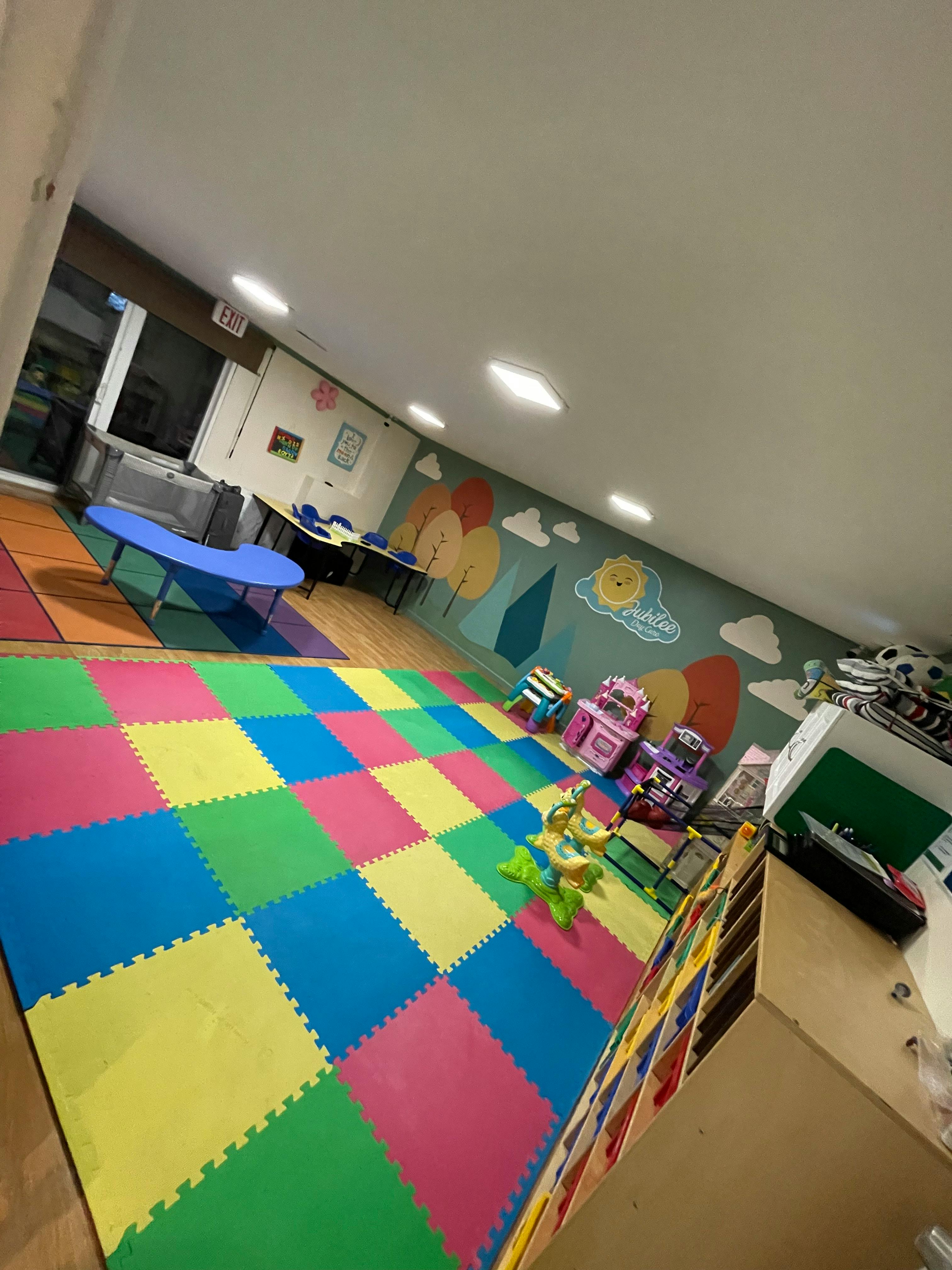 Playroom with colorful floor mats and wall murals
