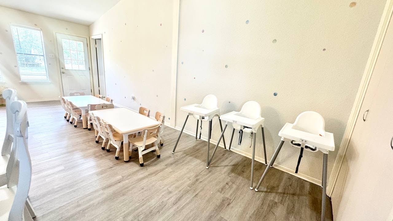 Children's tables and high chairs in a room