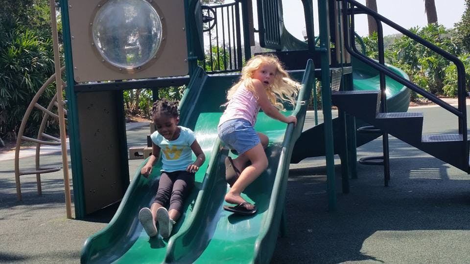 Two children on a playground slide