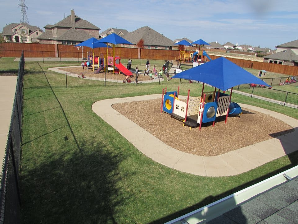 Outdoor playground with multiple play structures and children playing