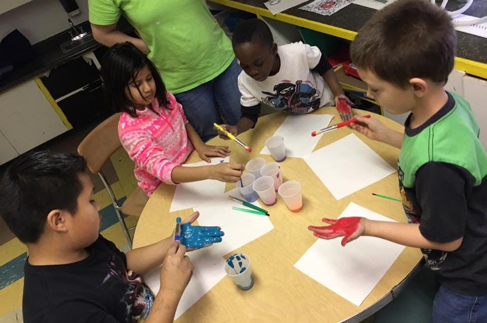 Children doing an art project with paint and paper