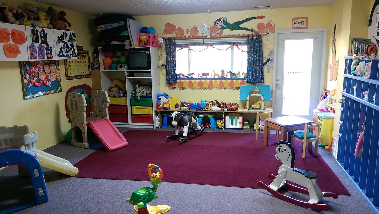 Playroom with toys, slides, and rocking horses