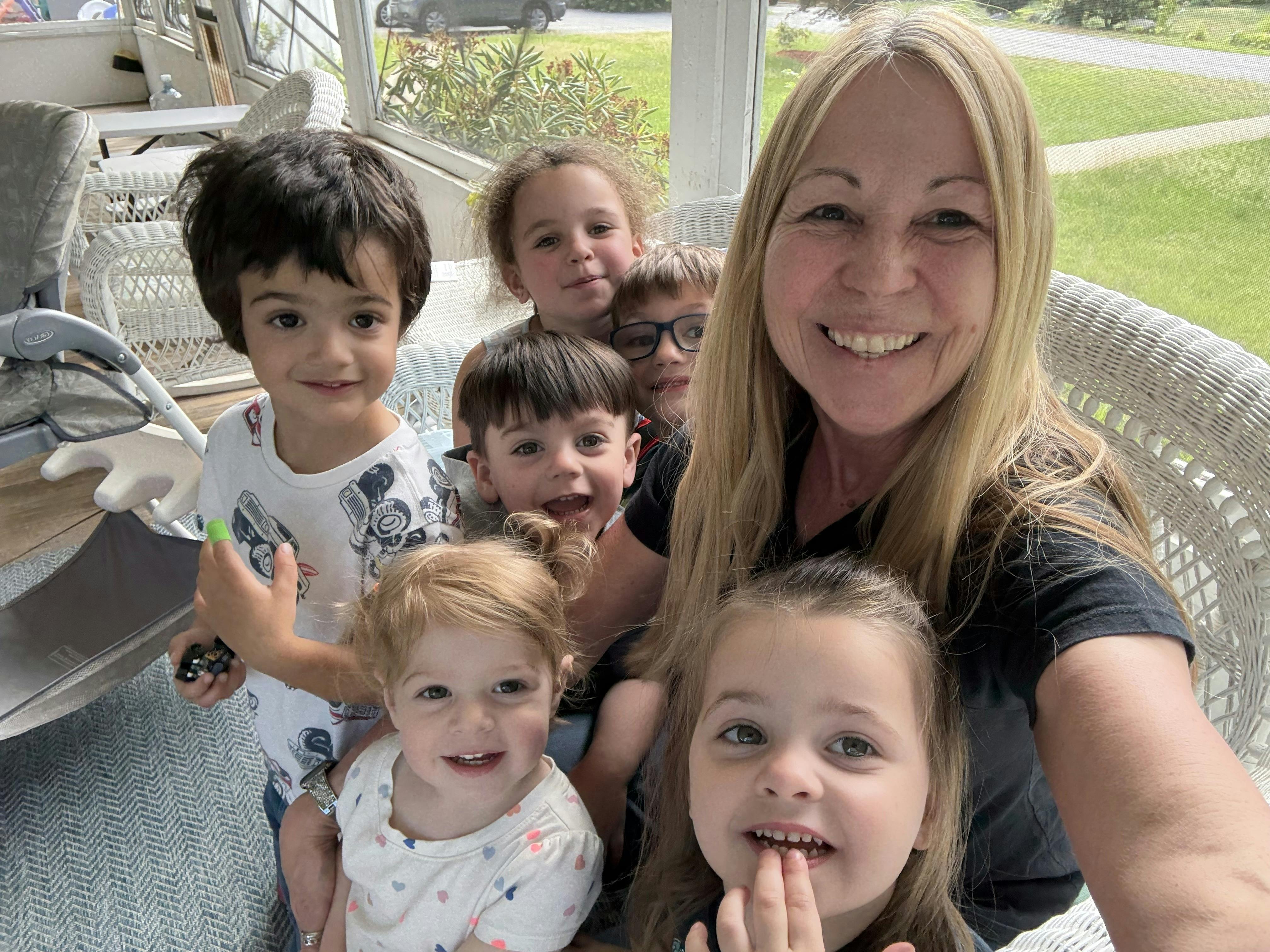 Person and multiple children posing for a photo
