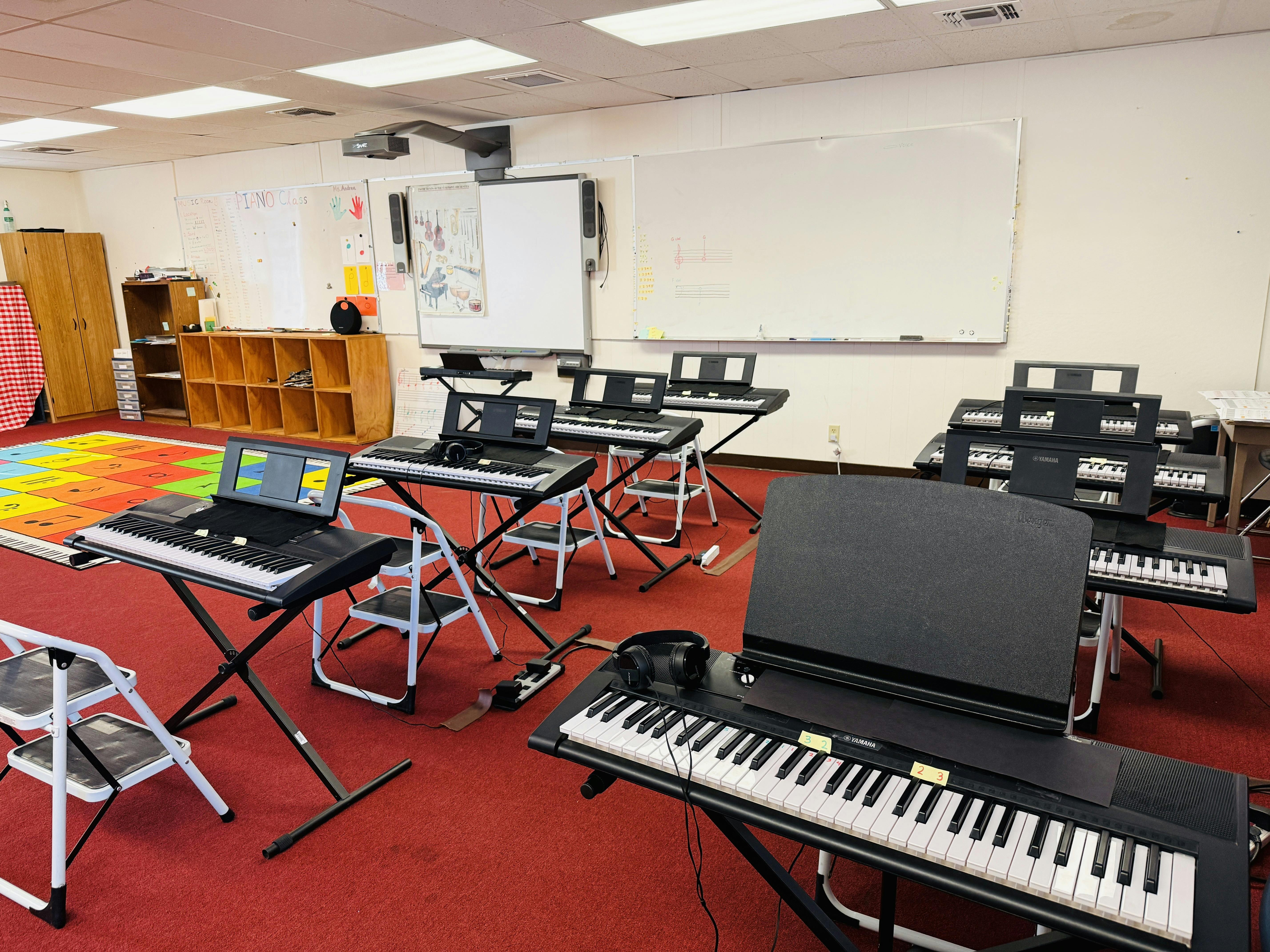 Multiple electronic keyboards arranged in a music classroom