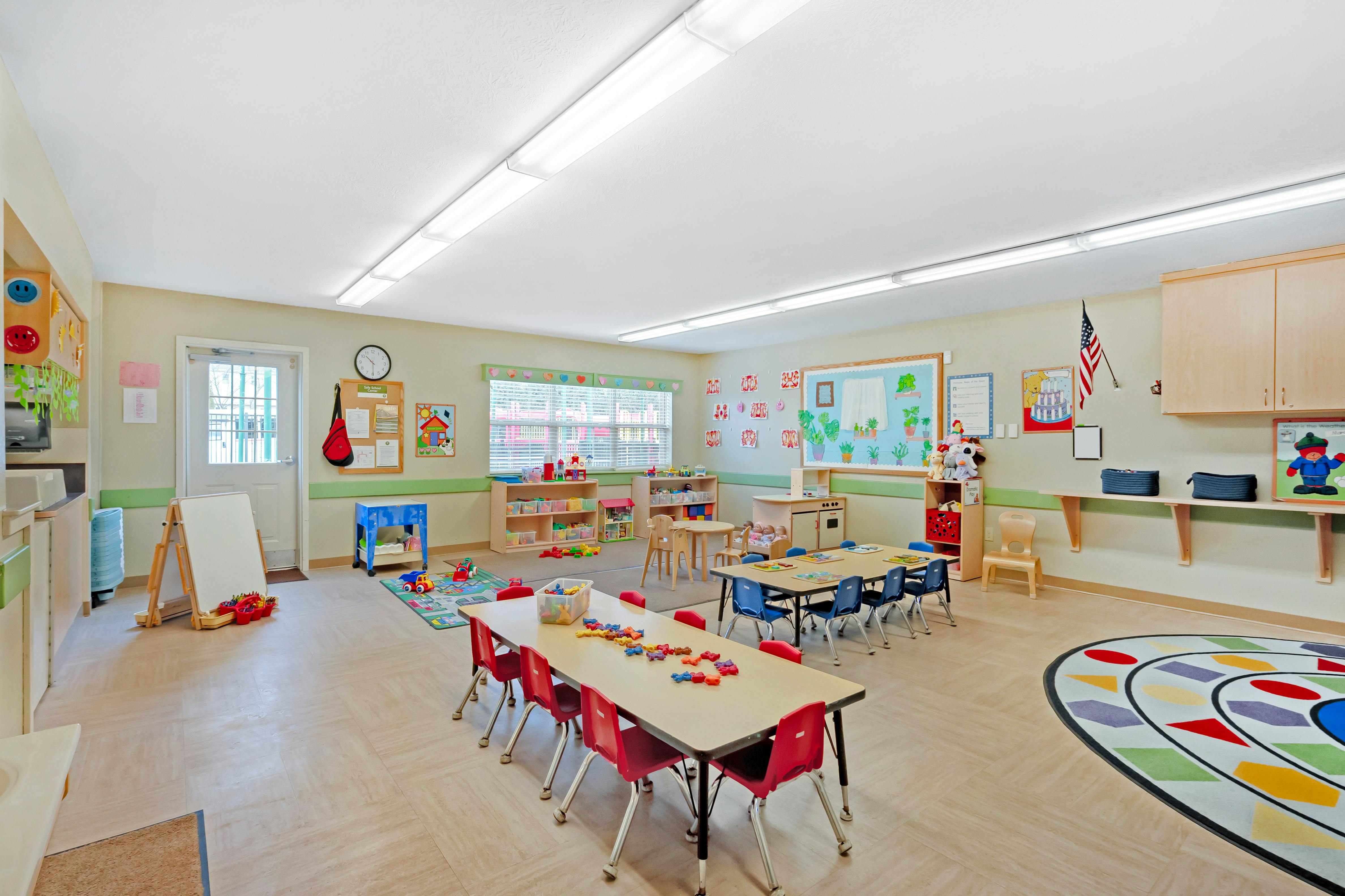 Classroom with tables, chairs, toys, and learning materials