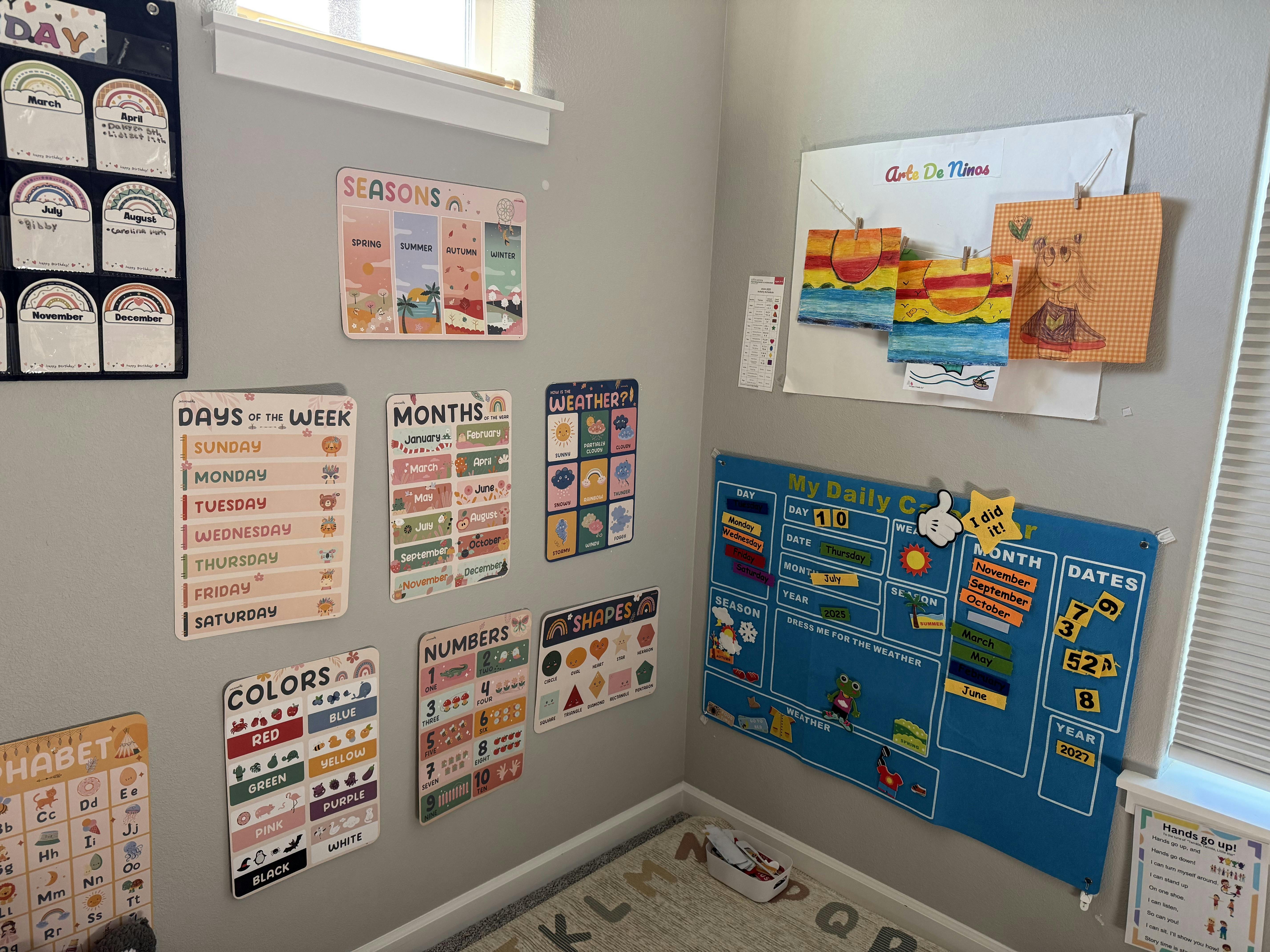 Wall with educational charts for days, months, colors, numbers, and seasons