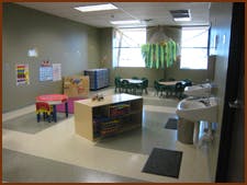 Empty classroom with small tables and chairs