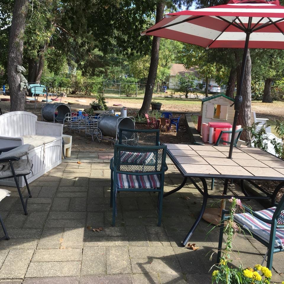 Patio with outdoor furniture and a red and white umbrella