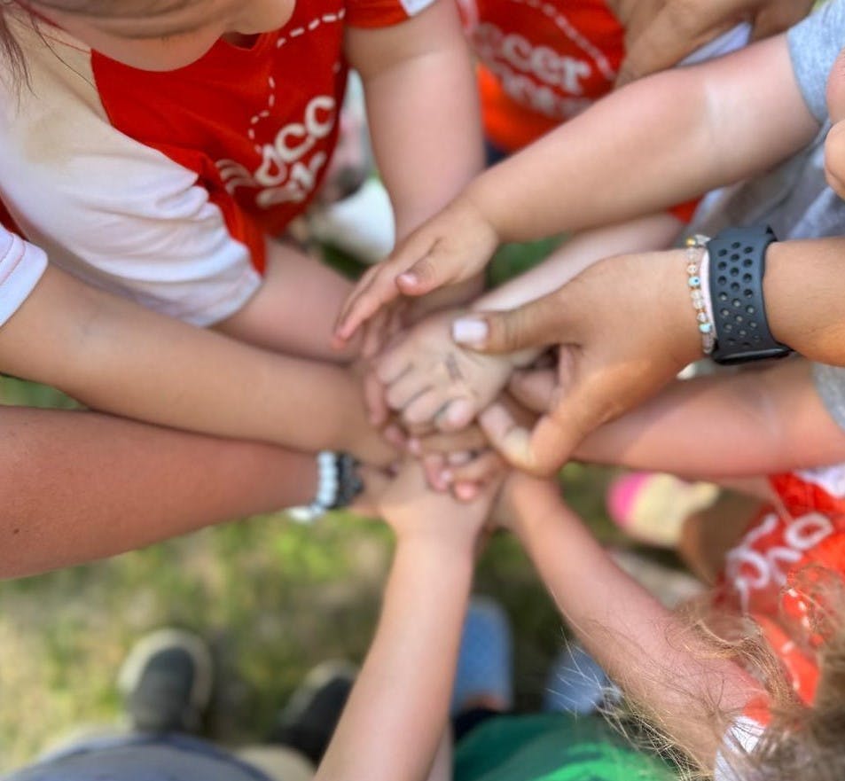 Multiple children's hands stacked together