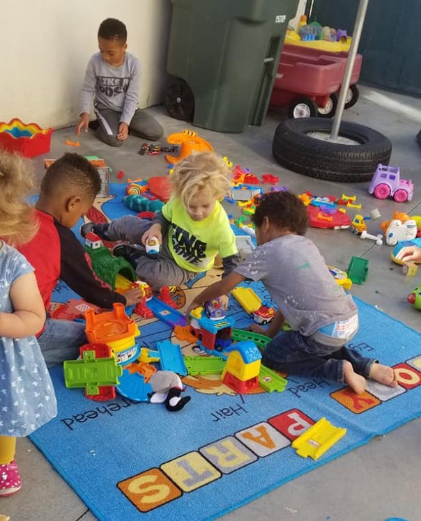 Children playing with toys on a mat