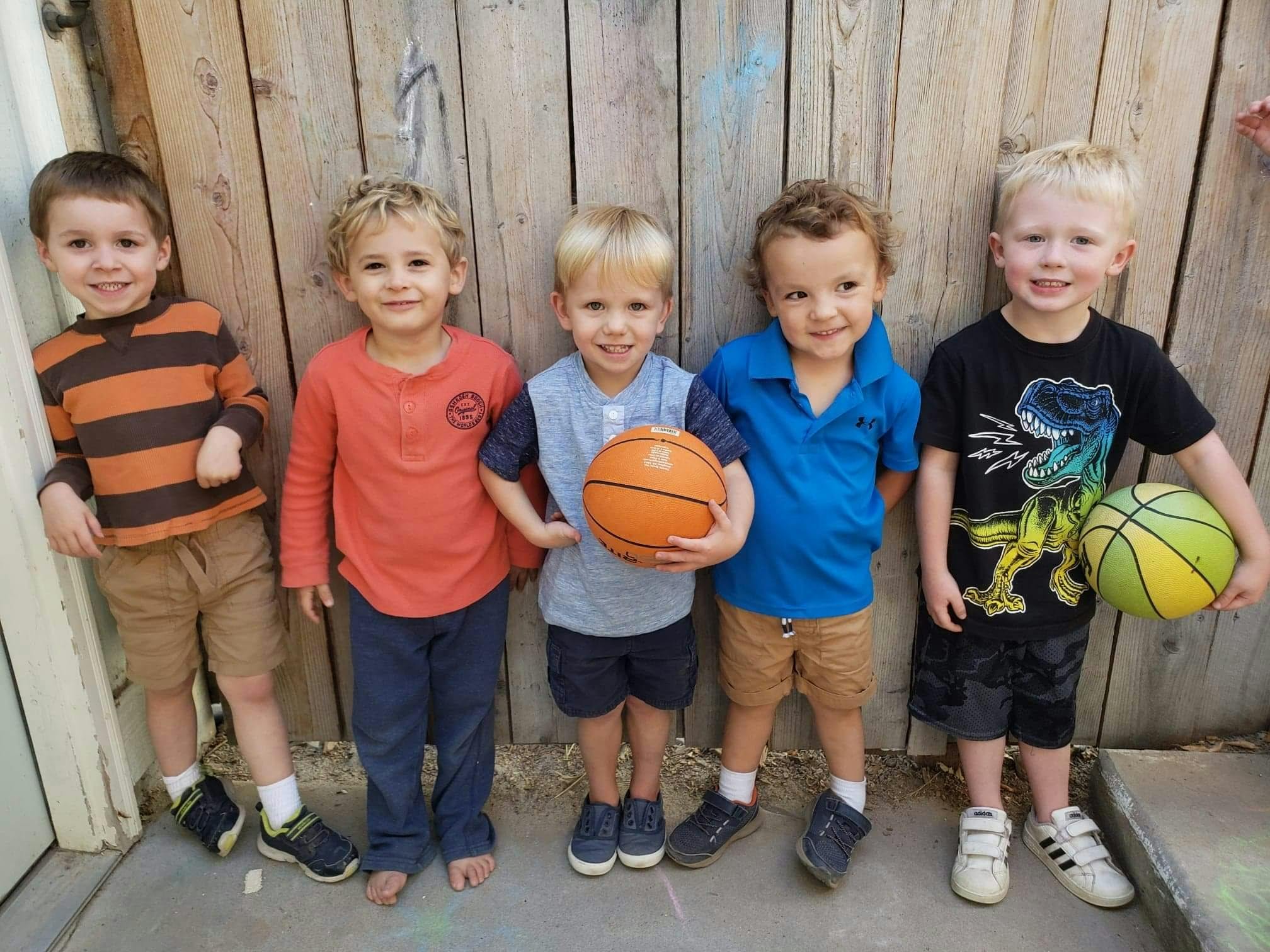 Five children standing with basketballs