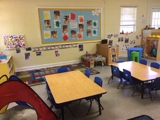 Empty classroom with small tables and chairs