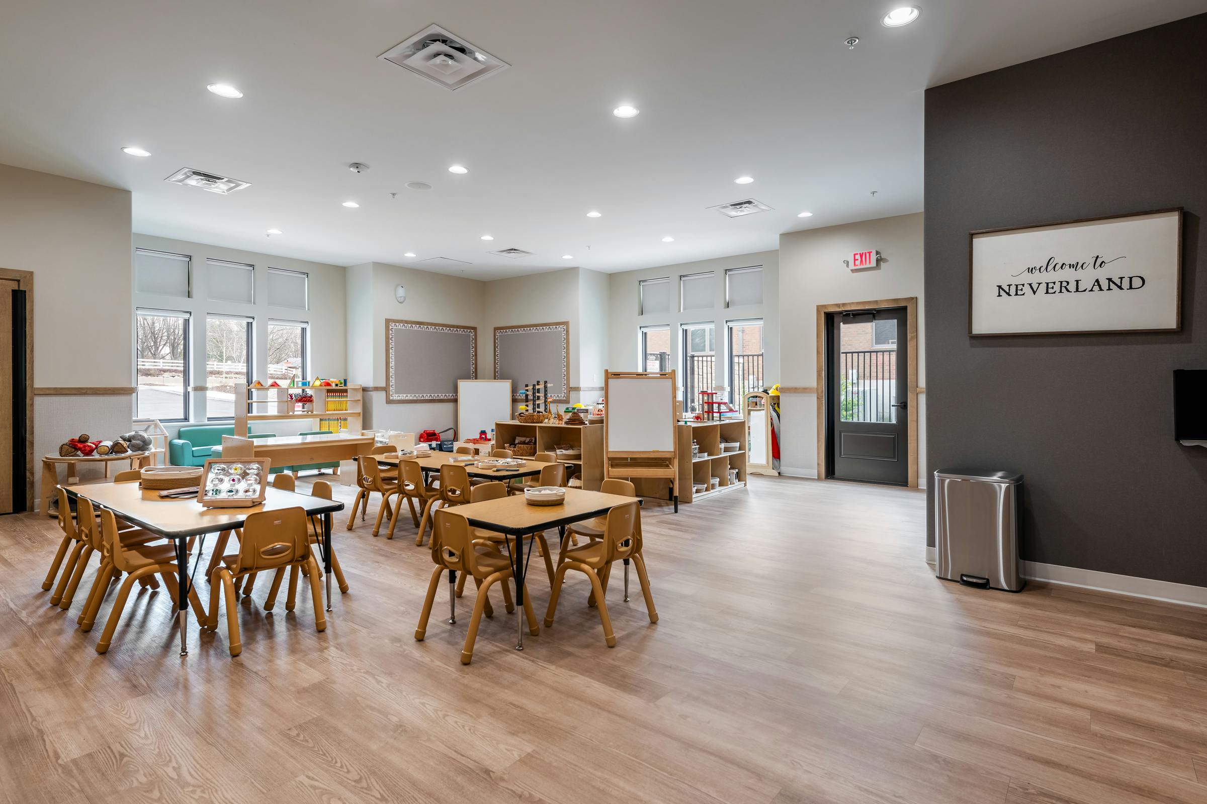Classroom with small tables and chairs, Welcome to Neverland sign
