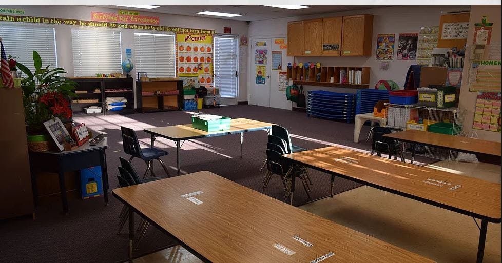 Empty classroom with tables and chairs