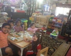 Children sitting around a table with food