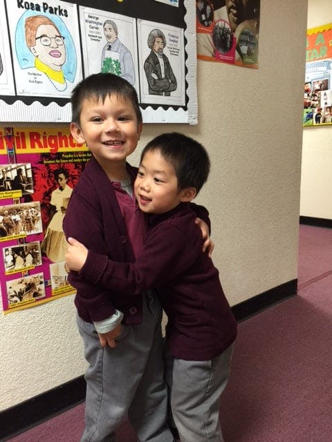 Two children hugging and smiling