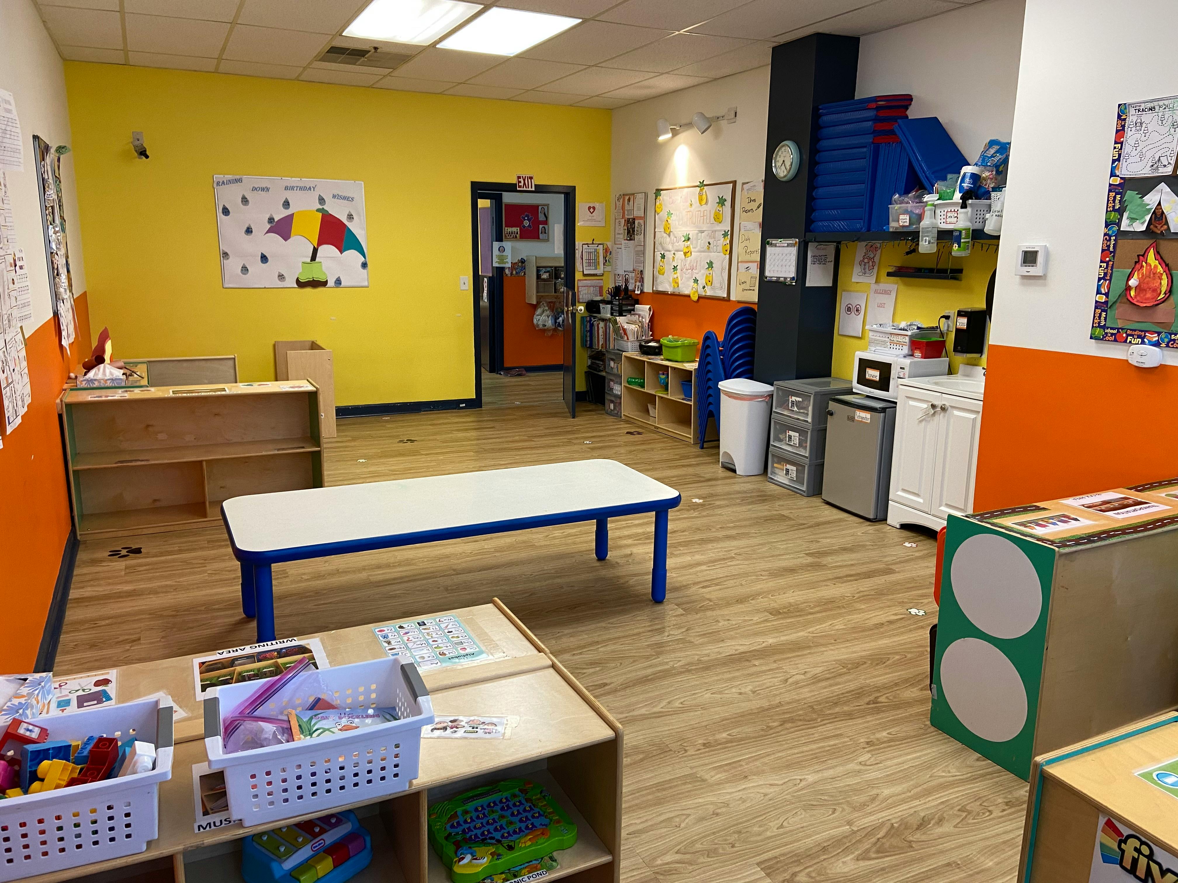 Empty classroom with tables and shelves