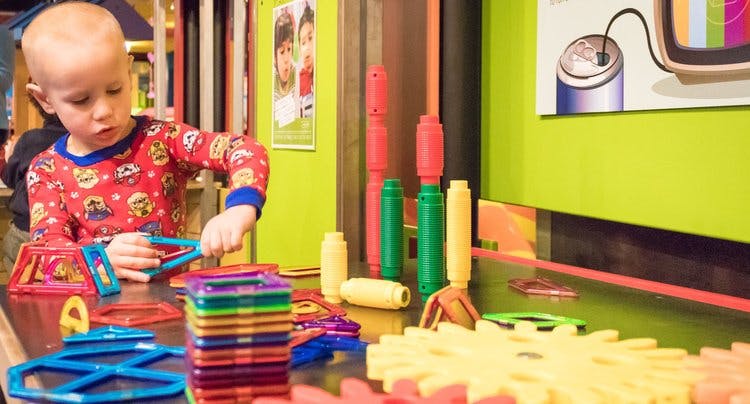 Child playing with colorful magnetic building toys
