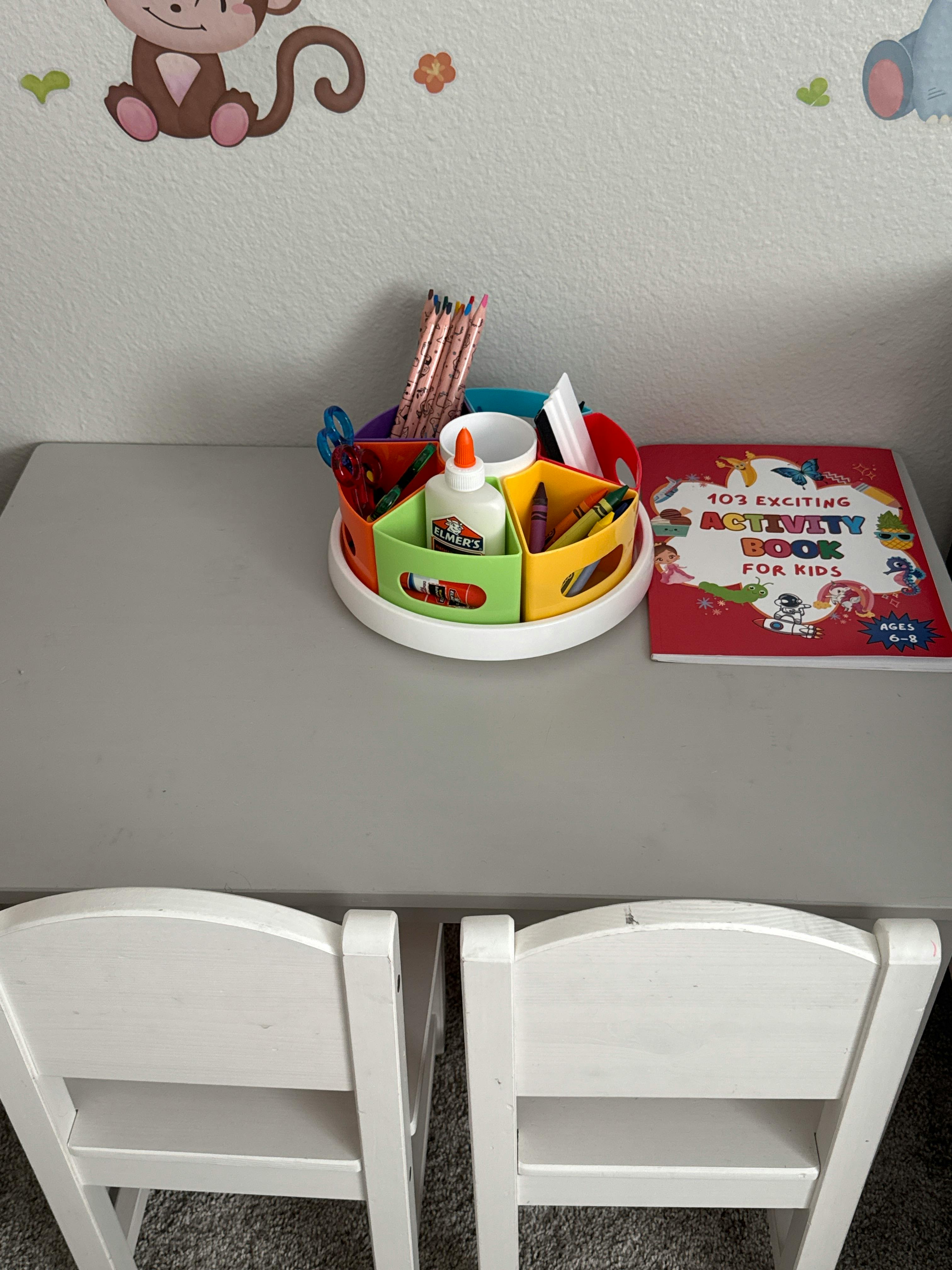 Activity book and circular art supply organizer on a table