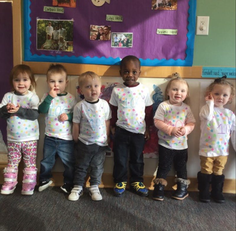 Six children standing in a row