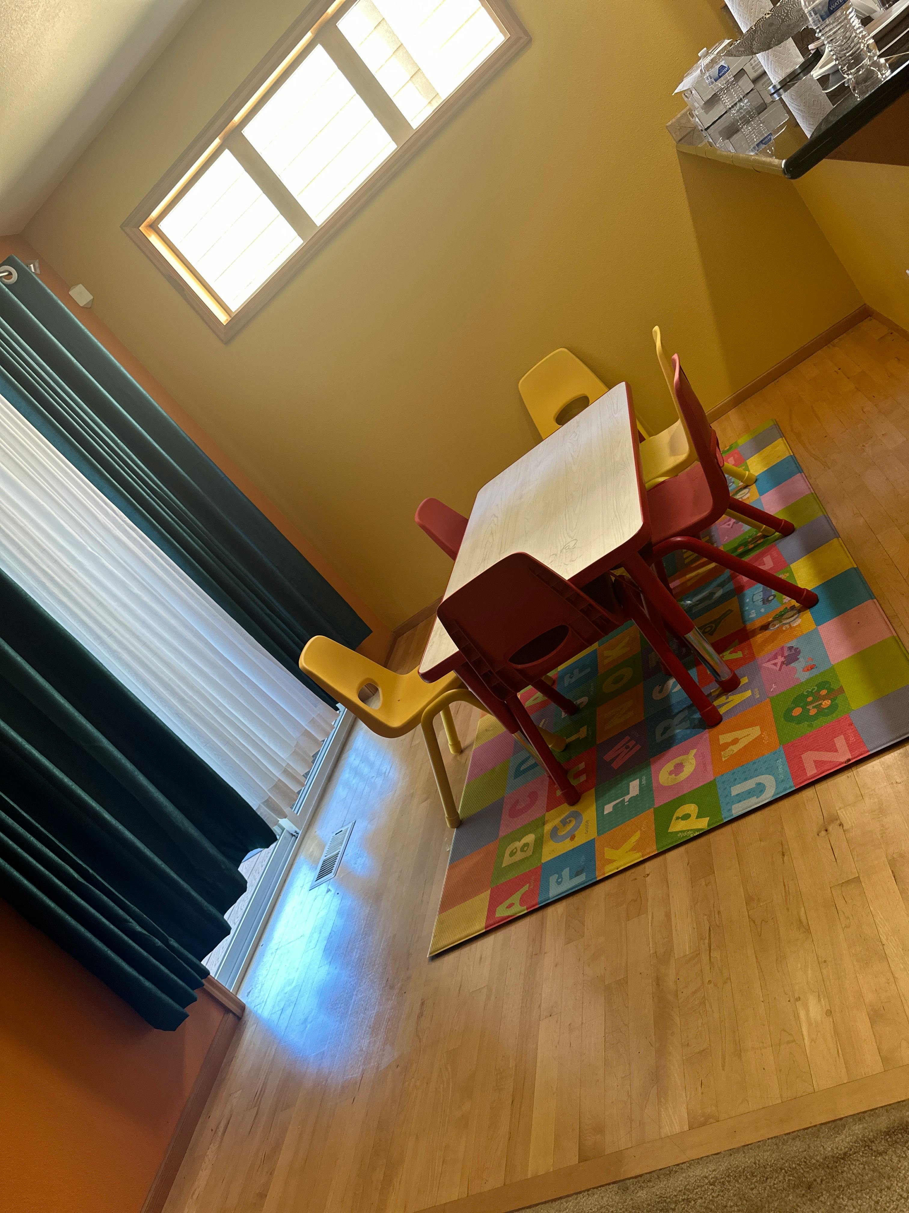 Small table with chairs on an alphabet rug