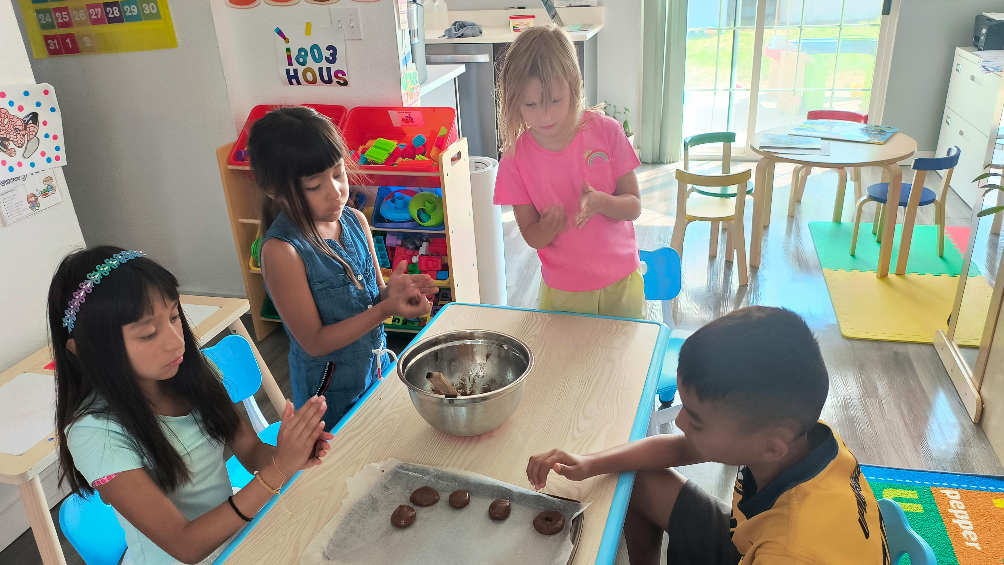 Children making cookies at a table
