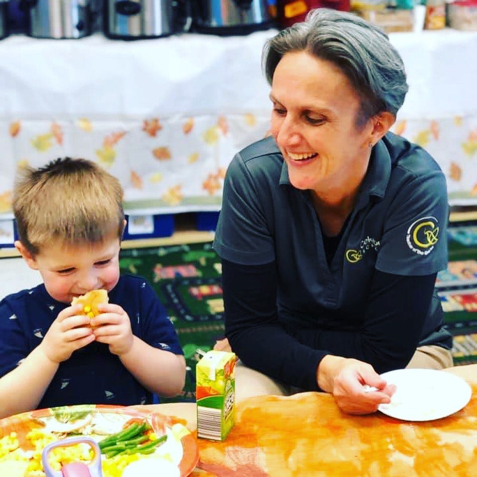 Adult and child eating at a table