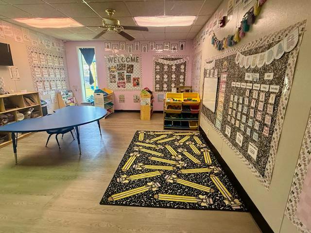Classroom interior with a pencil-patterned rug and learning materials