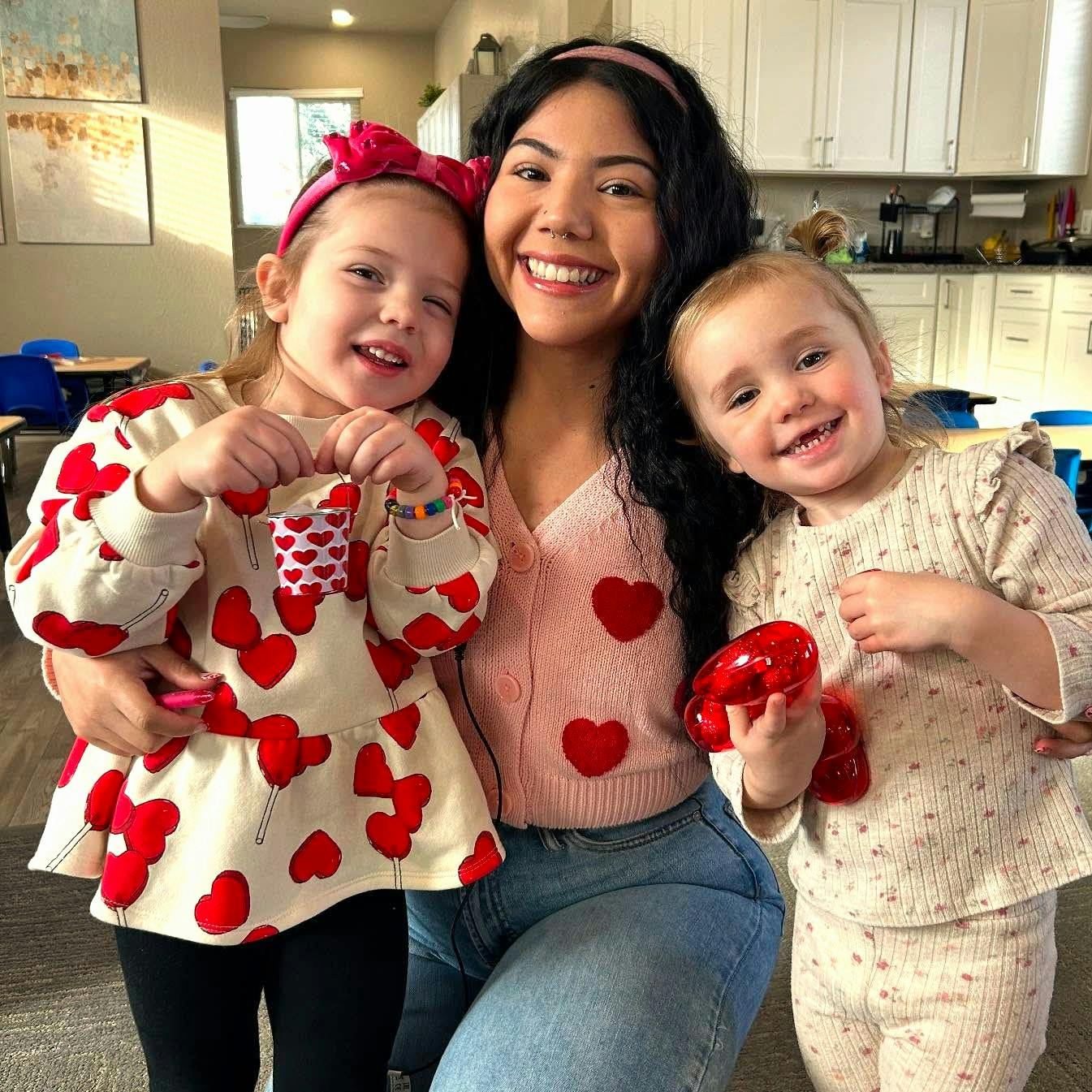 Person with two children, all smiling