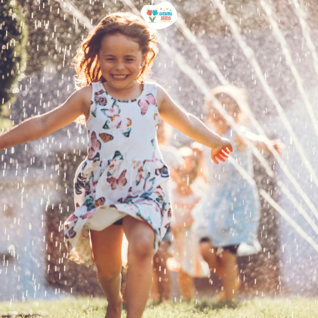 Child running through water from a sprinkler
